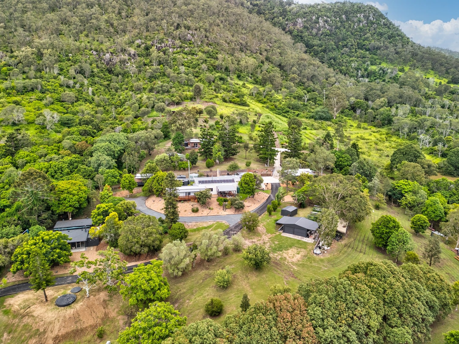 Aerial view of The Archer Retreat buildings amongst lush green hills
